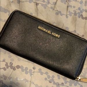 Large black Michael Kors wallet with gold trim